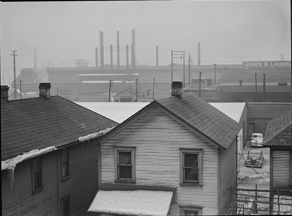 Workers' houses on the hillside at Aliquippa, Pennsylvania, with the Jones and Laughlin steel works behind them, January 1941