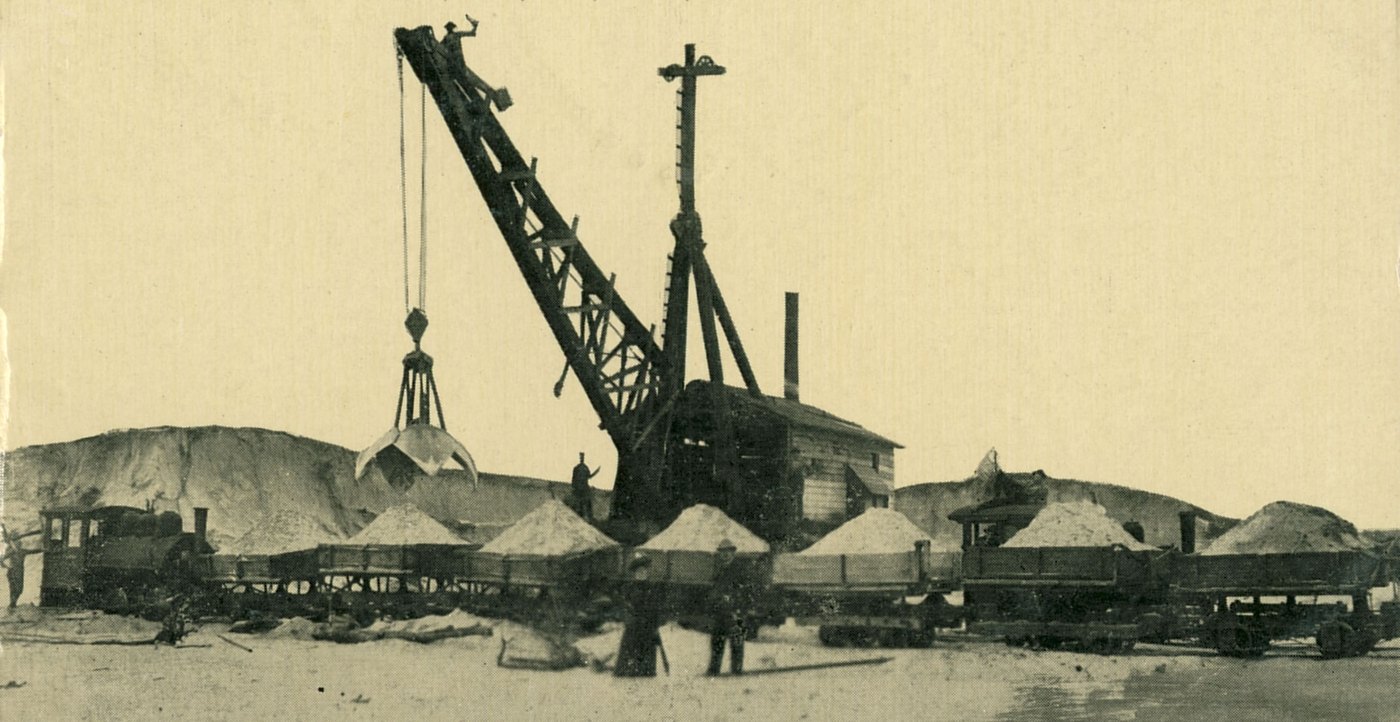 A steam shovel loading dune sand into a train of dump cars, Gary, May 1907