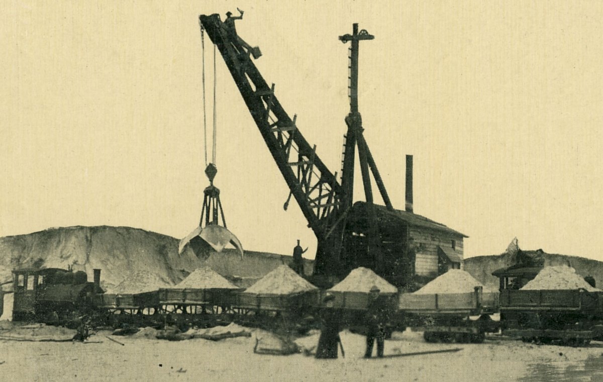 A steam shovel loading sand from the dunes into railroad cars at the site of Gary, Indiana, May 1907