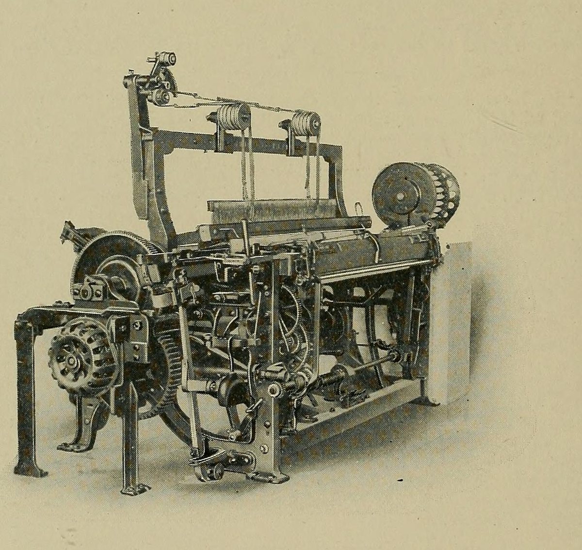 A Northrop automatic loom shown side-on, with its round filling battery at one end