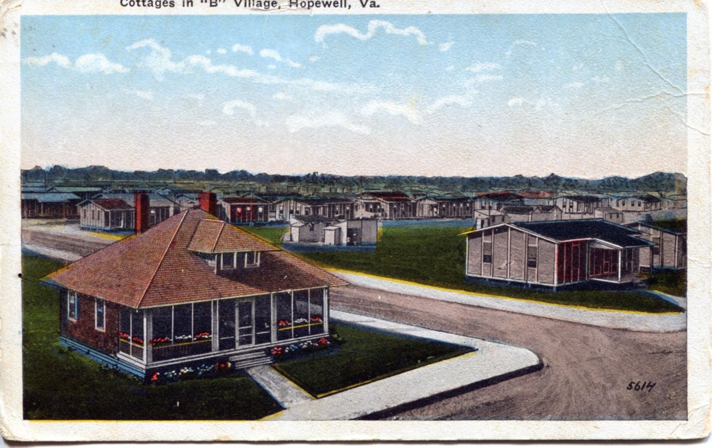 A hand-coloured postcard of a bungalow with a screened porch and rows of small company houses behind it