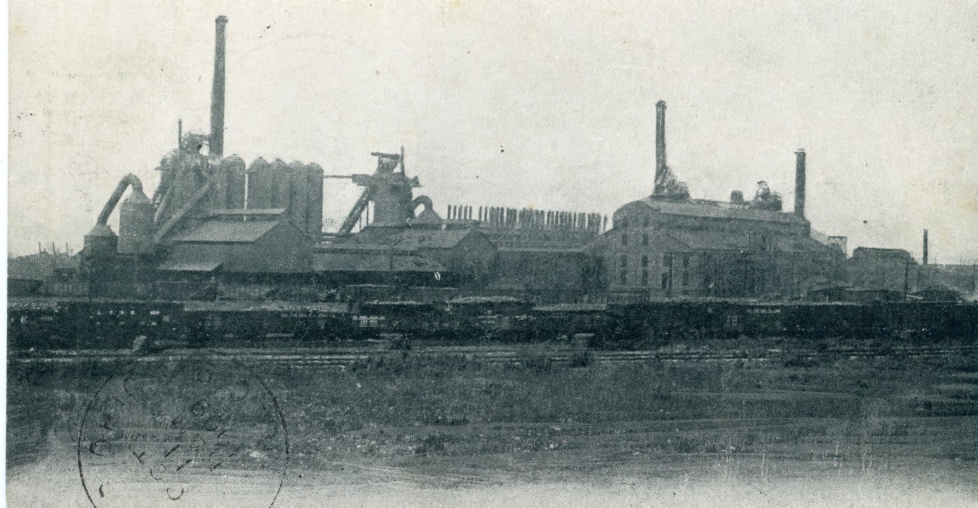 The blast furnaces and power house of the National Tube Company at Lorain, beyond the railroad yard, on a postcard postmarked 1909