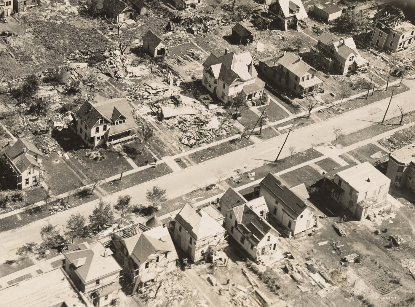 Aerial photograph of a Lorain residential street after the tornado of June 1924, with houses shifted and debris across the yards