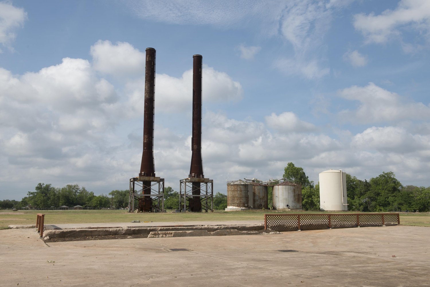 Two surviving stacks on the cleared slab of the Imperial Sugar refinery site, Sugar Land, Texas